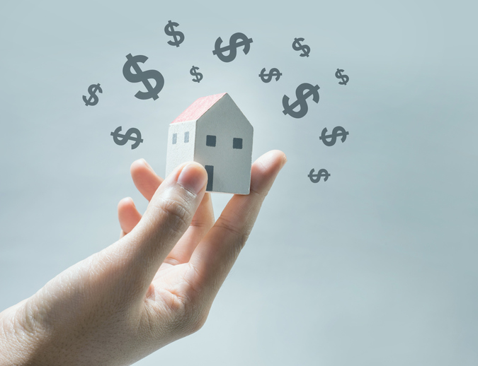 graphic of hand holding miniature house